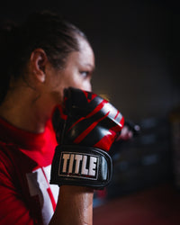 variant:red/black::TITLE MMA Contender Training Gloves red/black on fighter's hands taking fighting stance