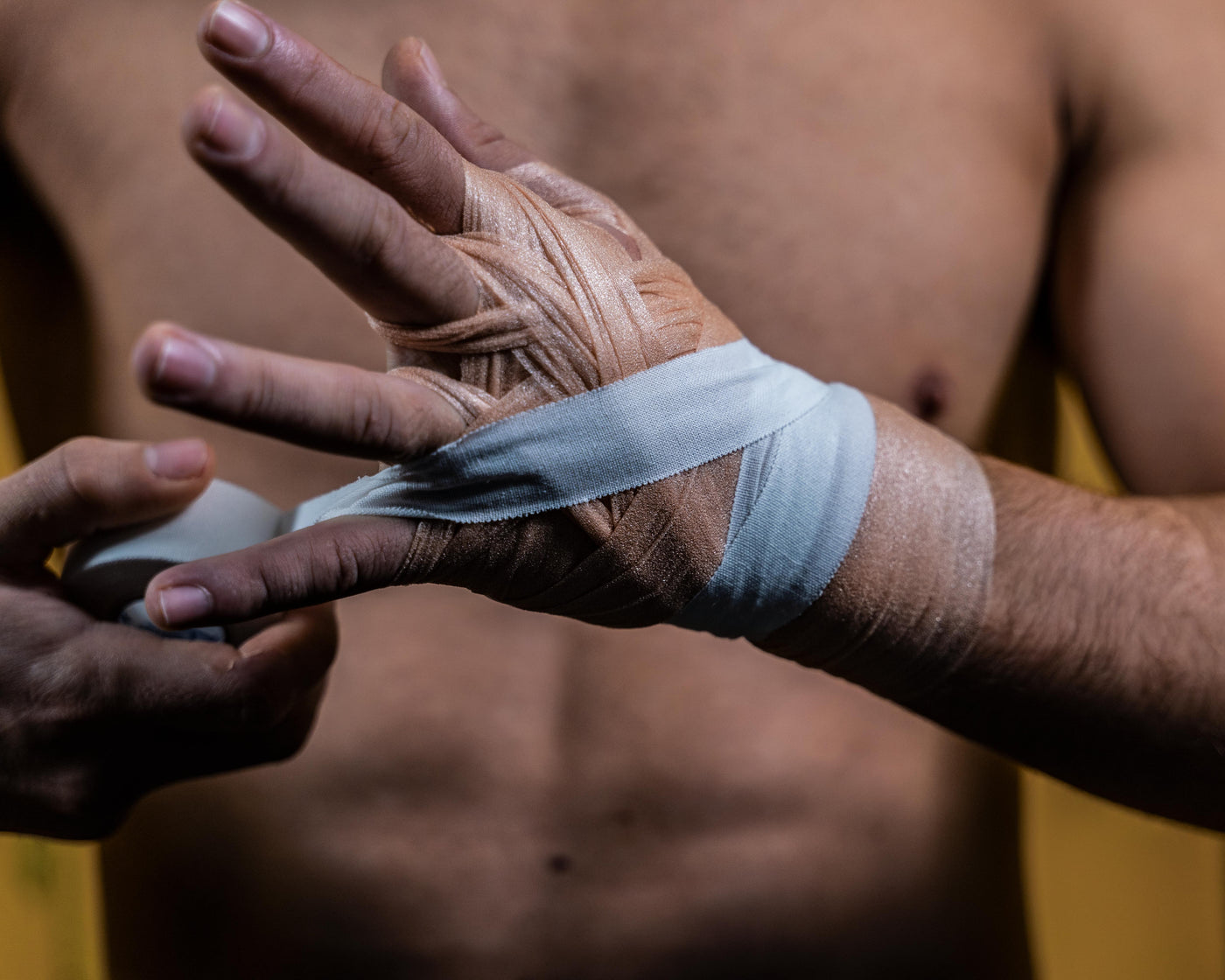 variant:lifestyle::TITLE Boxing Made in the USA 1" Tape (8 Rolls) being applied to hands