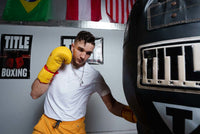 variant:lifestyle::TITLE Boxing Gloves Necklace guy hitting bag