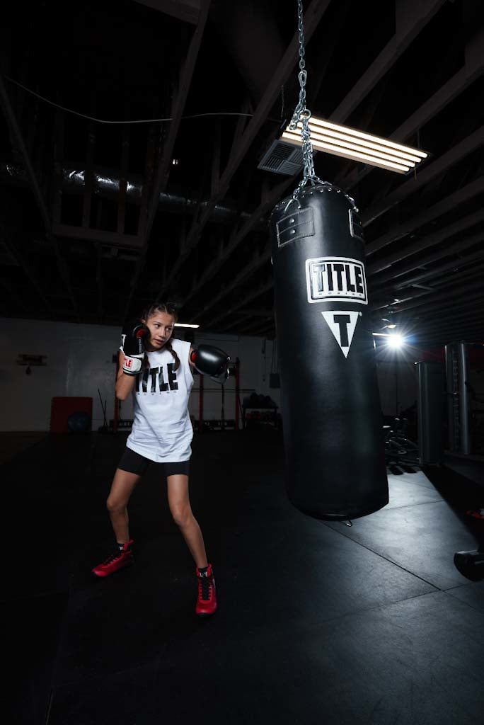 variant:lifestyle::TITLE Boxing Professional Choice 125lb Synthetic Leather Heavy Bag little girl hitting bag red shoes