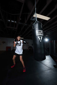 variant:lifestyle::TITLE Boxing Professional Choice 125lb Synthetic Leather Heavy Bag little girl hitting bag red shoes