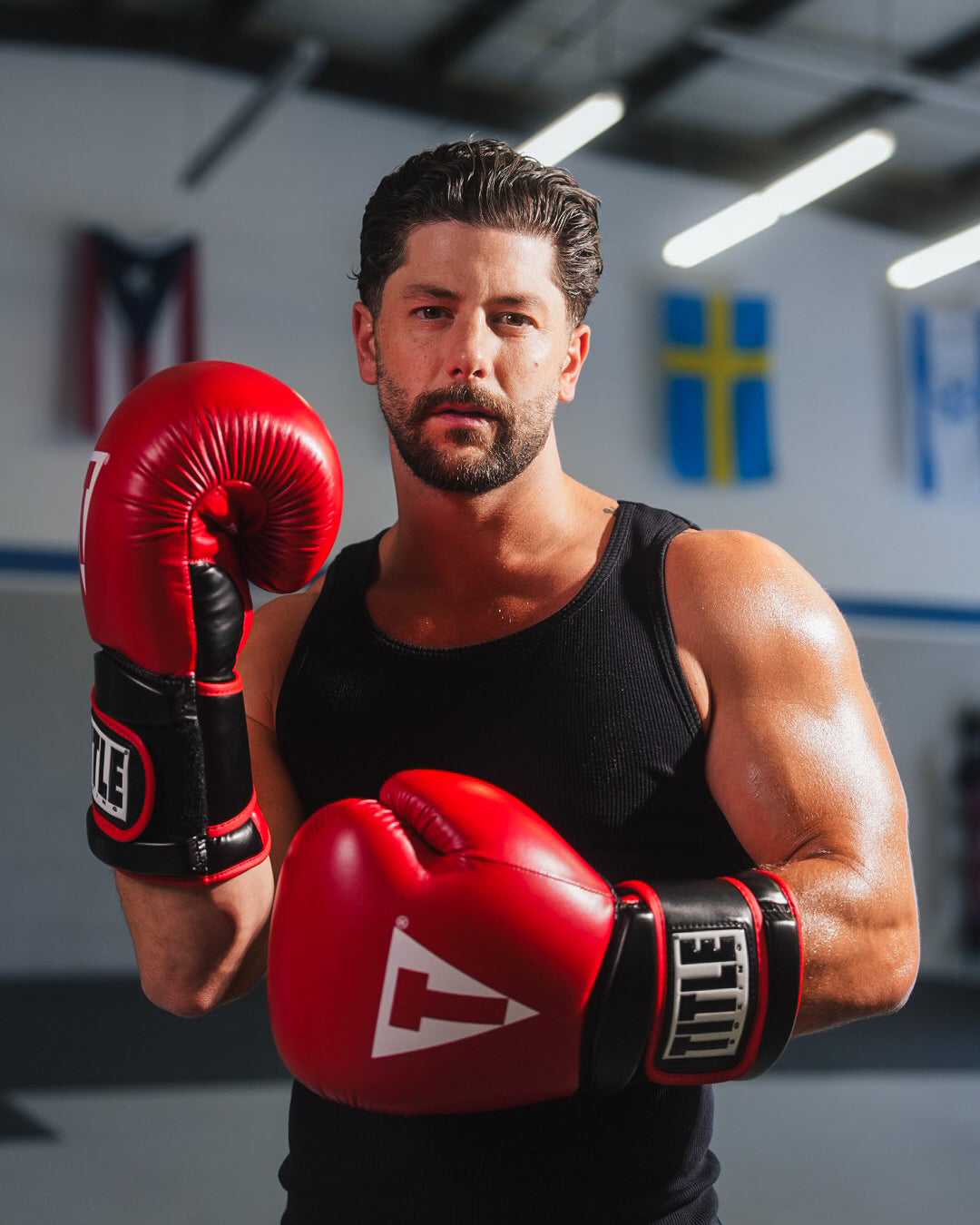 variant:red/black::TITLE Boxing Oversize SAFE-T Contact Gloves boxer in the gym wearing gloves