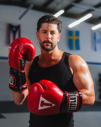 variant:red/black::TITLE Boxing Oversize SAFE-T Contact Gloves boxer in the gym wearing gloves