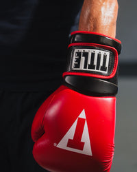 variant:red/black::TITLE Boxing Oversize SAFE-T Contact Gloves closeup of glove on fighter's hand