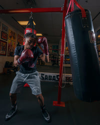variant:maroon::TITLE Boxing Old School Leather Sparring Gloves 2.0  boxing stance with bag