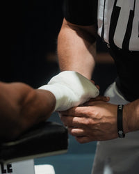 variant:lifestyle::TITLE Boxing Old School Super Gauze (50 Rolls) fighter's hand being wrapped