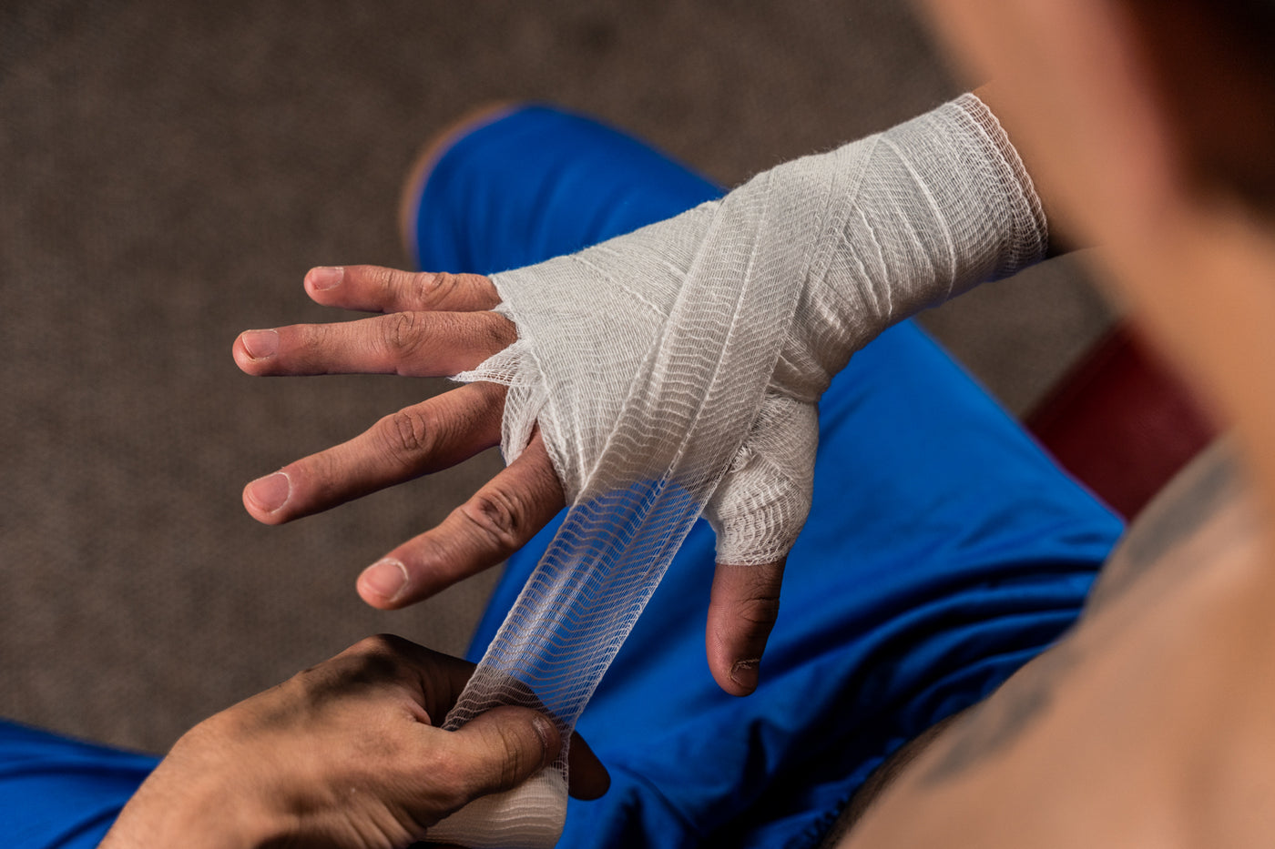 variant:lifestyle::TITLE Boxing Tape & Gauze Bundle boxer wrapping hand