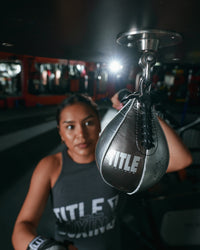 variant:lifestyle::TITLE Platinum Atomic Pro Speed Bag Girl hitting bag