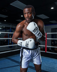 variant:white/black::TITLE Boxing Leather Pro Fight Gloves boxing stance