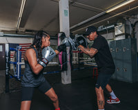 variant:lifestyle::TITLE Platinum Prolific Punch Mitts girl coach mitts