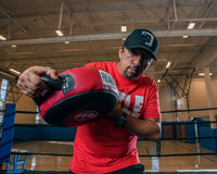 variant:lifestyle::Pro Mex Accuarcy Pro Punch Shield 2.0 coach holding down the shield motion