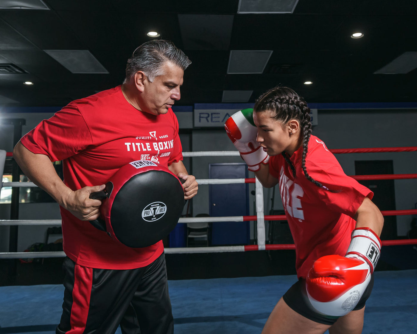 variant:lifestyle::Pro Mex Accuracy Leather Pro Punch Shield 2.0 girl left hook