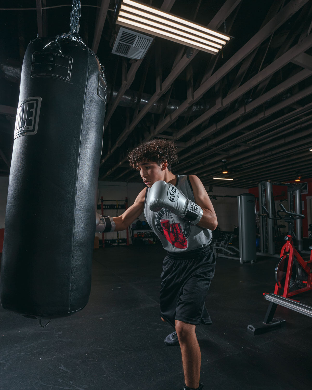 variant:Silver::Pro Mex Professional Bag Gloves V3.0 guy hitting bag right jab