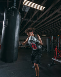 variant:Silver::Pro Mex Professional Bag Gloves V3.0 guy hitting bag right jab