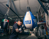 variant:Black::Pro Mex Professional Bag Gloves V3.0 guy hitting heavy teardrop bag