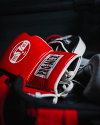 variant:red::Pro Mex Professional Edge Lace Training/Sparring Boxing Gloves in gym bag