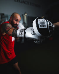 variant:silver::Pro Mex Professional Edge Lace Training/Sparring Boxing Gloves on fighter punching mitt