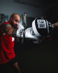 variant:lifestyle::Pro Mex Professional Micro Mitts being hit by boxer