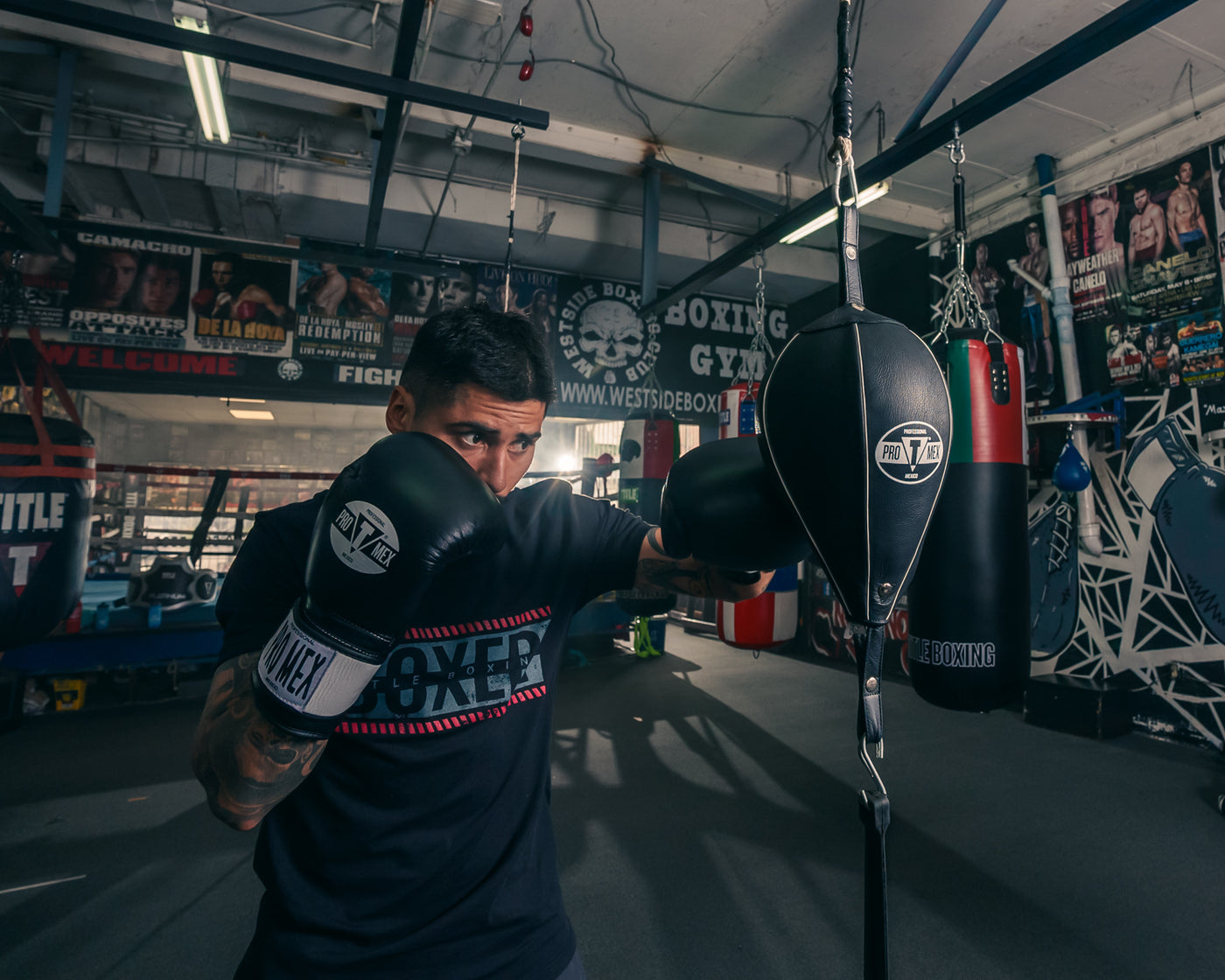 variant:7" x 11"::Pro Mex Professional Double End Bag V2.0 guy hitting the bag with a jab