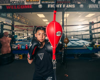 variant:5" x 9"::Pro Mex Professional Double End Bag V2.0 girl hitting the bag with the left hand