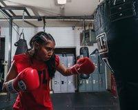 variant:red::Pro Mex Professional Training Gloves 3.0 girl hitting bag