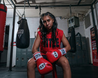 variant:red::Pro Mex Professional Training Gloves 3.0 girl sitting down