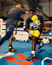 variant:yellow/black::Pro Mex Professional Lace Sparring Boxing Gloves V3.0 on fighter in the ring
