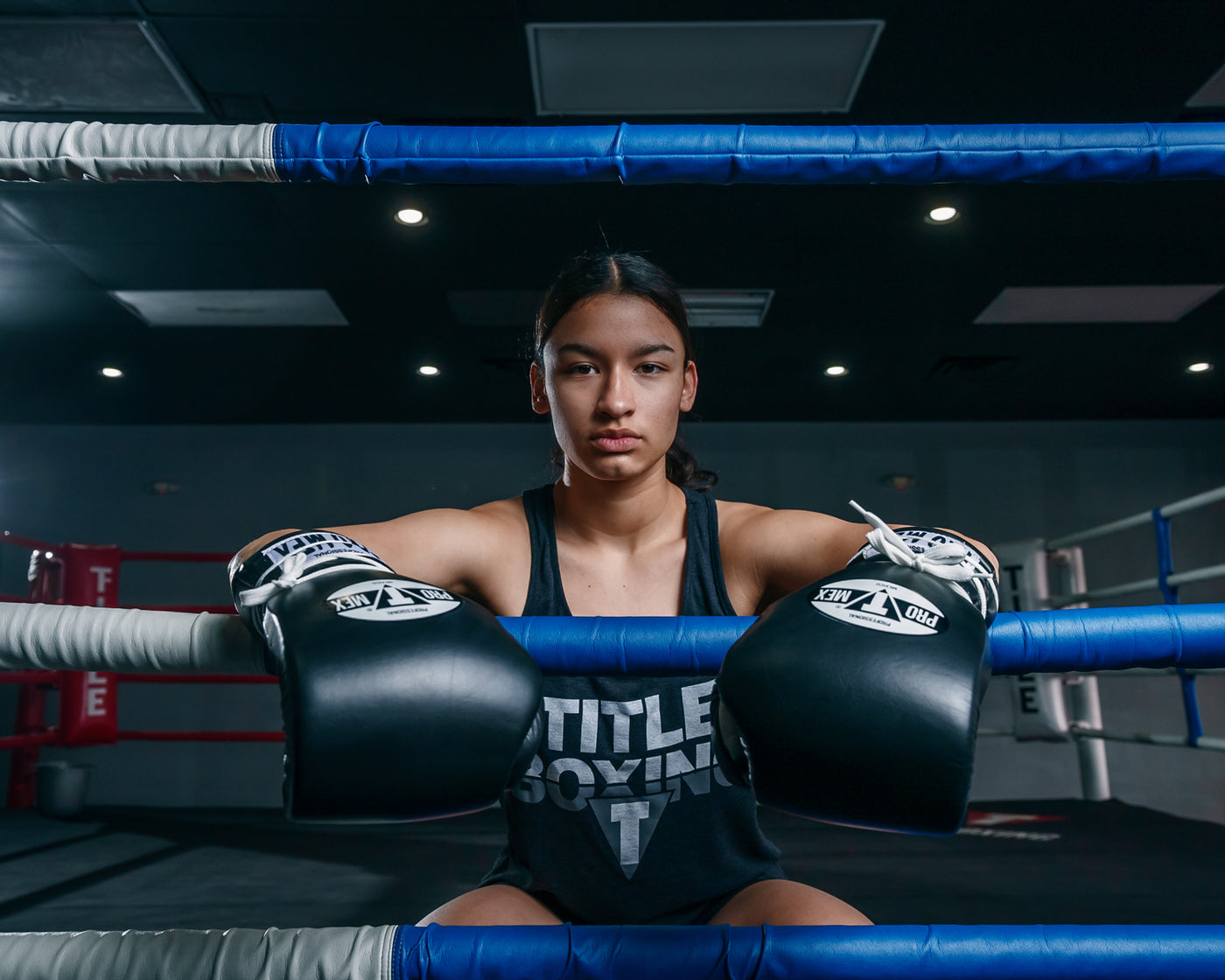 variant:Black/White::Pro Mex Professional Lace Sparring Gloves V3.0 girl sitting on ring