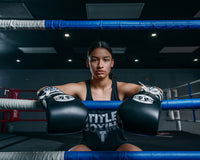 variant:Black/White::Pro Mex Professional Lace Sparring Gloves V3.0 girl sitting on ring