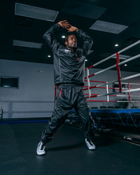 variant:lifestyle::TITLE Platinum Prevail Rubberized Sauna Suit jumping pose