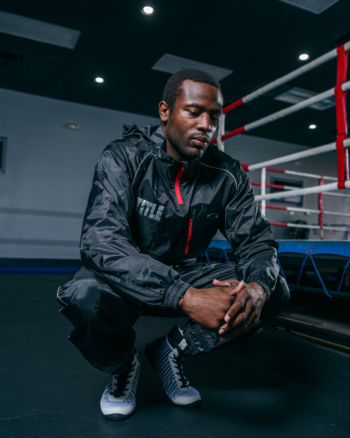 variant:lifestyle::TITLE Platinum Prevail Rubberized Sauna Suit squatting  pose