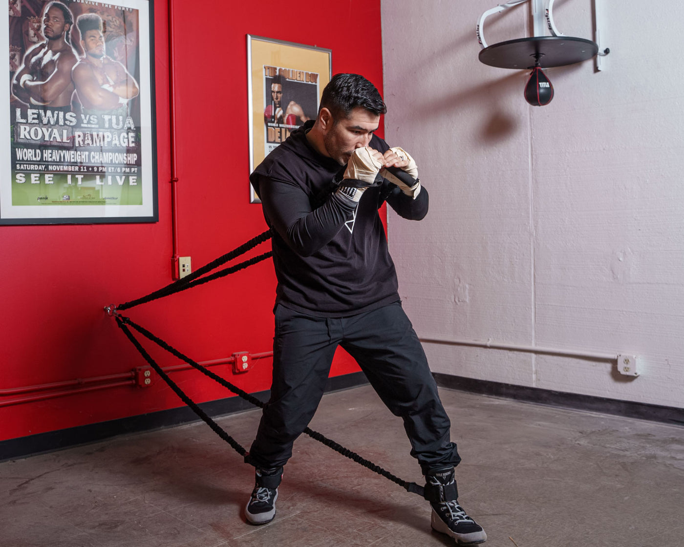 variant:lifestyle::TITLE Boxing Powerquad Resistance System on the wall of a boxing gym
