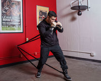 variant:lifestyle::TITLE Boxing Powerquad Resistance System on the wall of a boxing gym