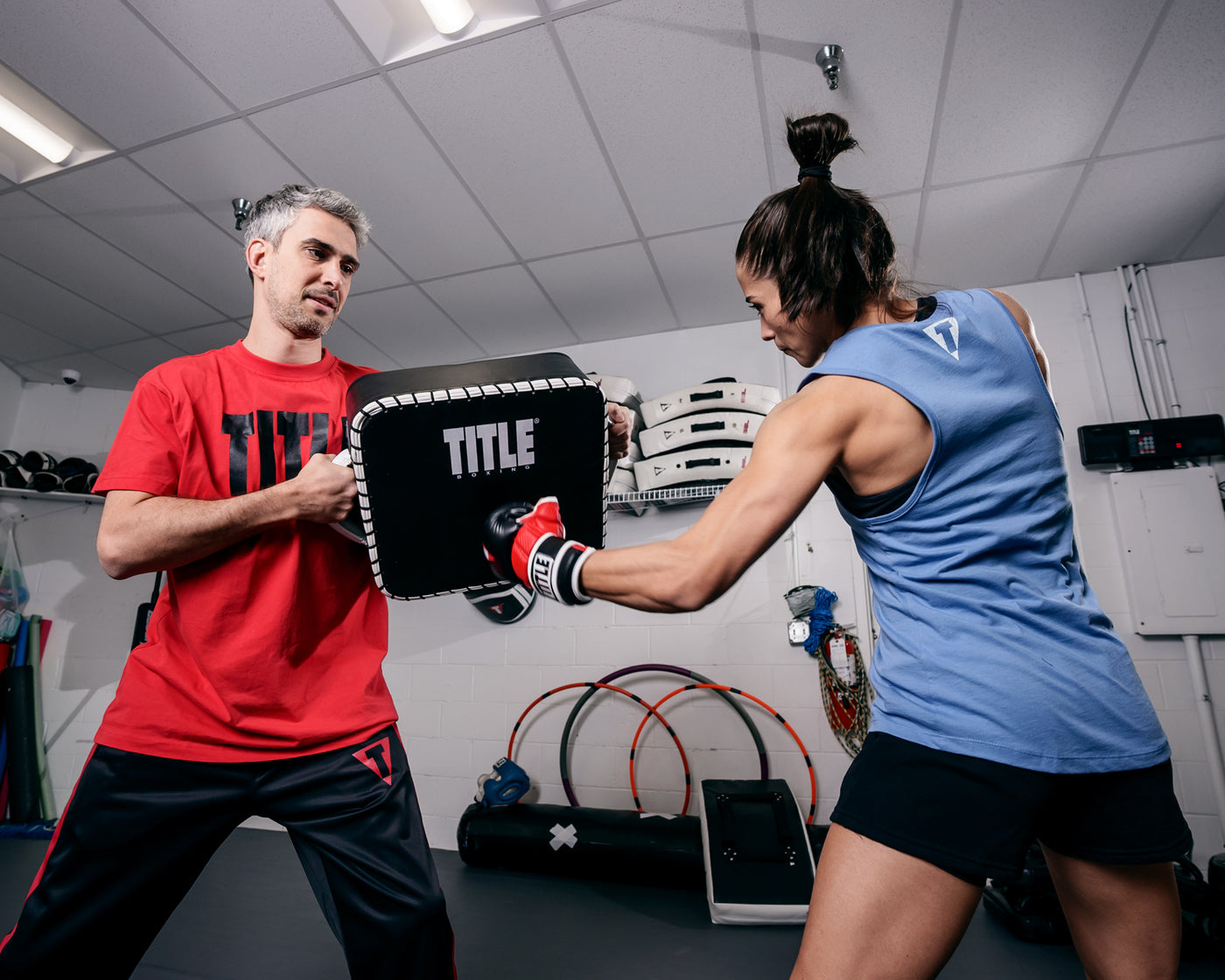 variant:Lifestyle::TITLE Boxing Square Punch and Kick Shield coach with lady