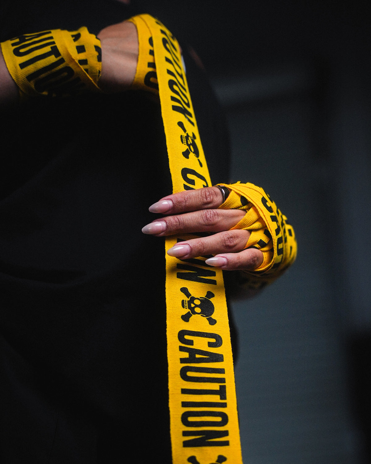 variant:caution::TITLE Boxing Print Mexican Style 180" Hand Wraps being rolled onto fighter's hands closeup