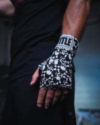 variant:skull and crossbones::TITLE Boxing Print Mexican Style 180" Hand Wraps closeup on boxer's hand