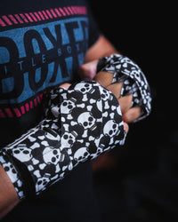 variant:skull and crossbones::TITLE Boxing Print Mexican Style 180" Hand Wraps closeup on boxer's hands