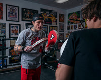 variant:lifestyle::TITLE Boxing Punch Training Paddles paddles with coach back of kid