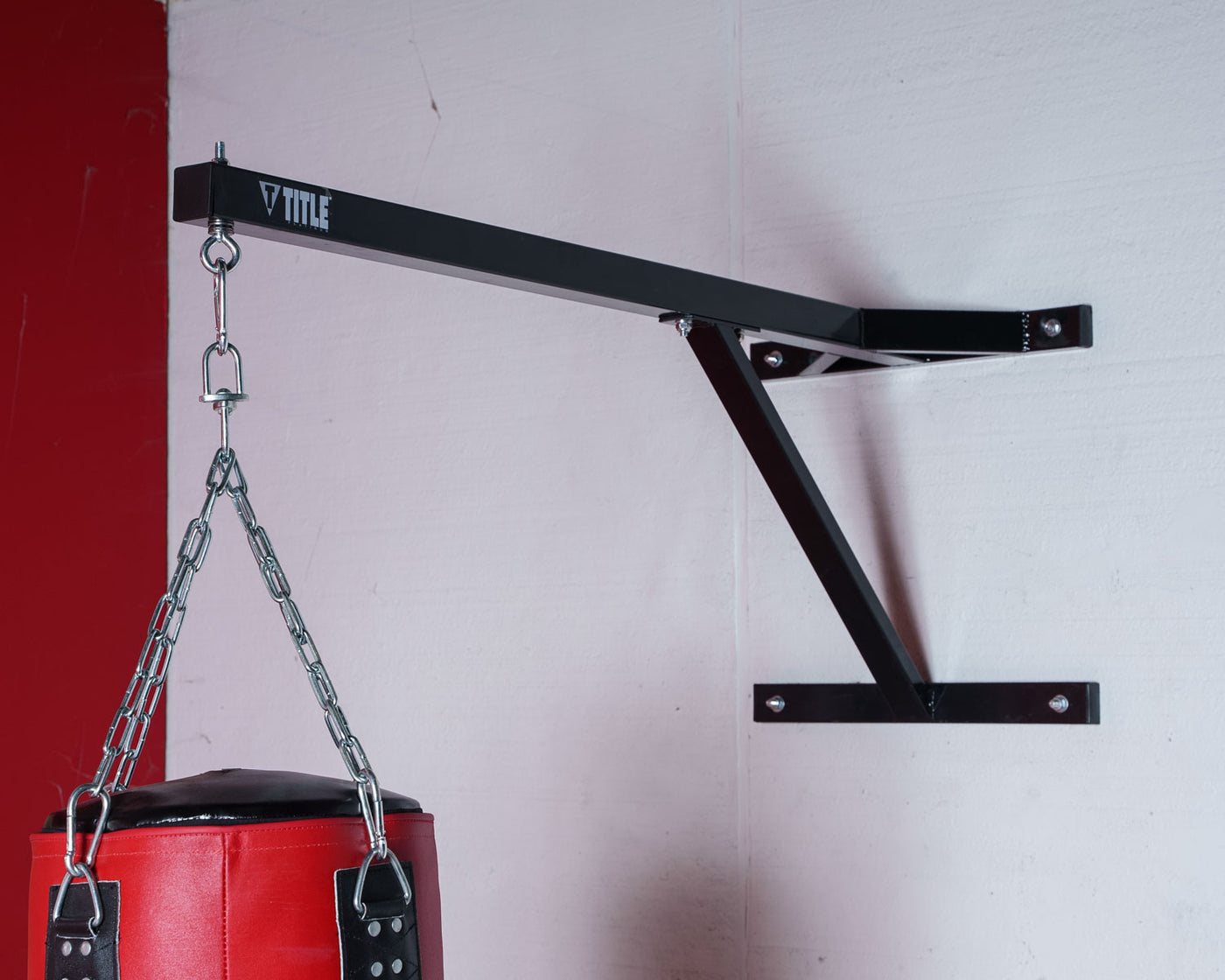 variant:lifestyle::TITLE Platinum Heavy Bag Wall Hanger 2.0 close up view in use with a heavy bag