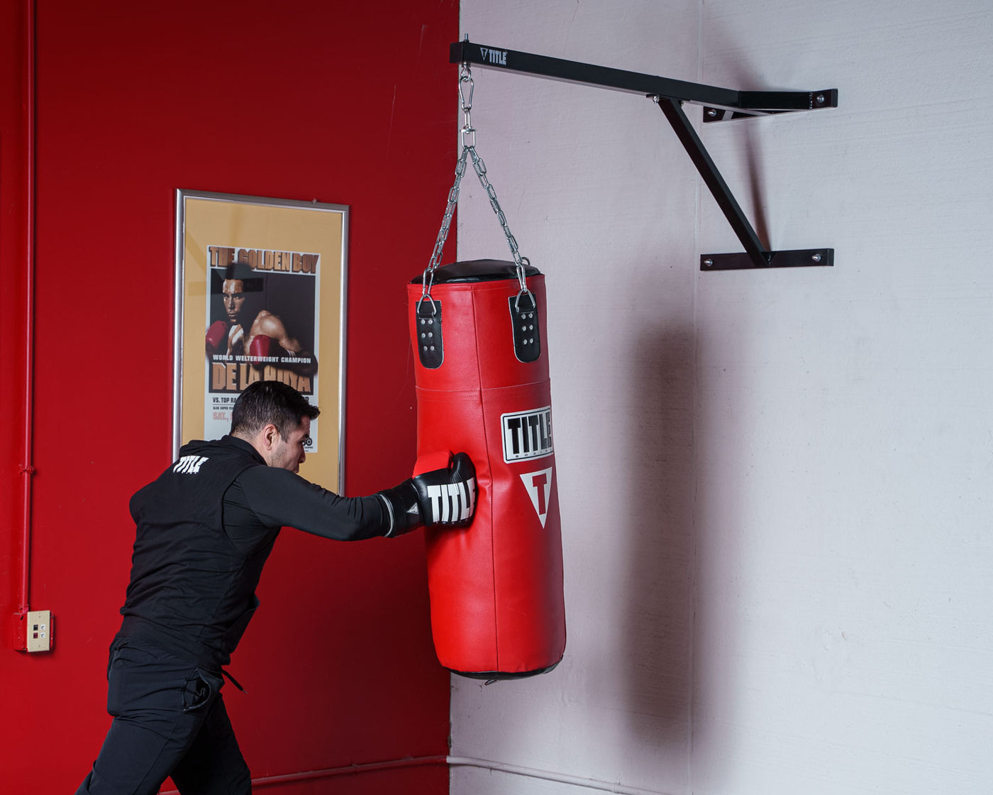 variant:lifestyle::TITLE Platinum Heavy Bag Wall Hanger 2.0 in use in a boxing gym