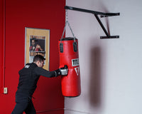 variant:lifestyle::TITLE Platinum Heavy Bag Wall Hanger 2.0 in use in a boxing gym