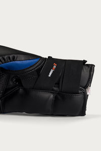 variant:blue::Close-up of a black martial arts glove with a blue interior lining and a black strap featuring the 'WRESTLE-IT 2' logo, set against a light gray background.