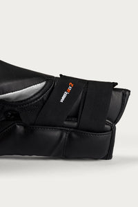 variant:Silver::Close-up of a black martial arts grappling sleeve with a hook-and-loop strap closure, featuring the West 1st 2 logo in white and orange, set against a light gray background.