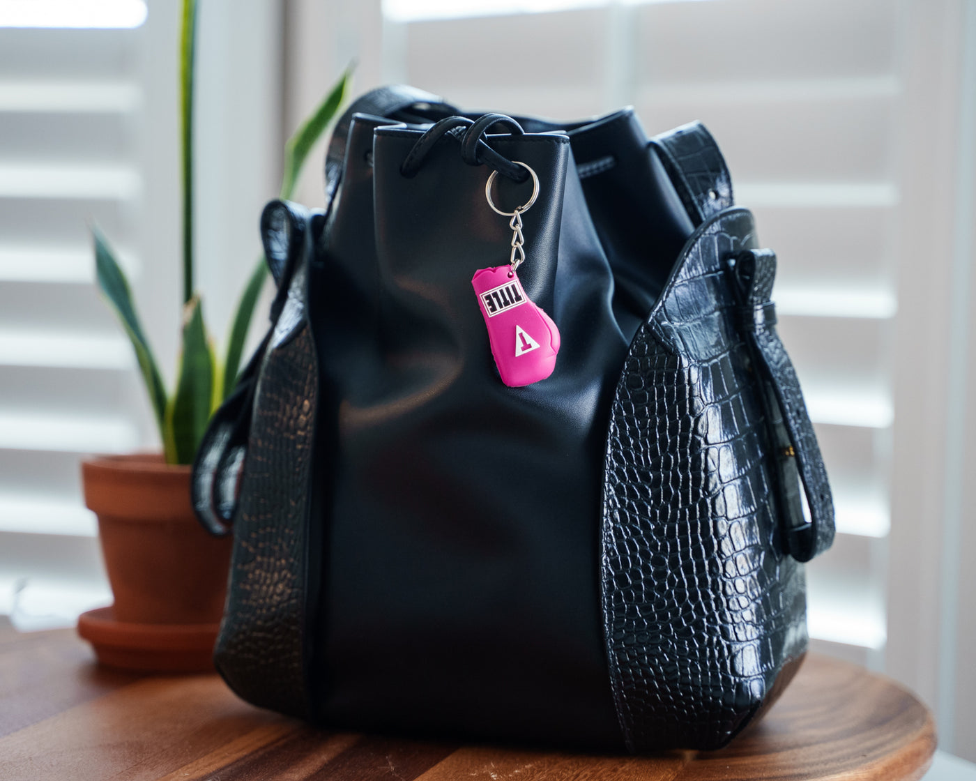 variant:pink::TITLE Boxing Molded Glove Keychain hanging on purse