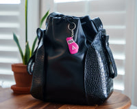 variant:pink::TITLE Boxing Molded Glove Keychain hanging on purse