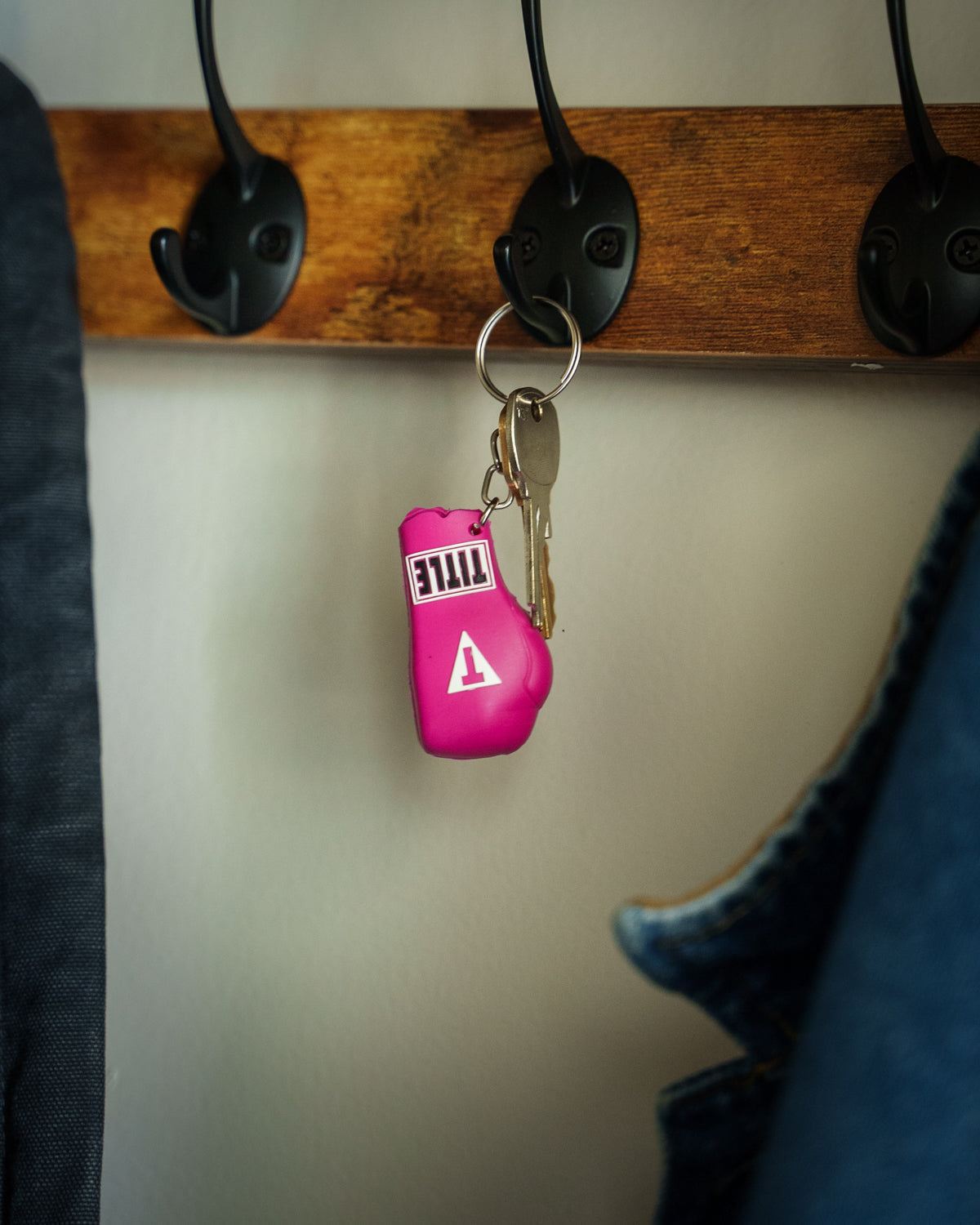 variant:pink::TITLE Boxing Molded Glove Keychain hanging on keyhook