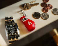variant:red::TITLE Boxing Molded Glove Keychain next to watch