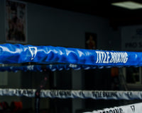 variant:blue::TITLE Boxing Pro Vinyl Zippered Rope Cover 4.0 image showing rope cover on boxing ring