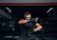 variant:lifestyle::TITLE Boxing Roberto Duran Hand Wraps guy putting on wraps
