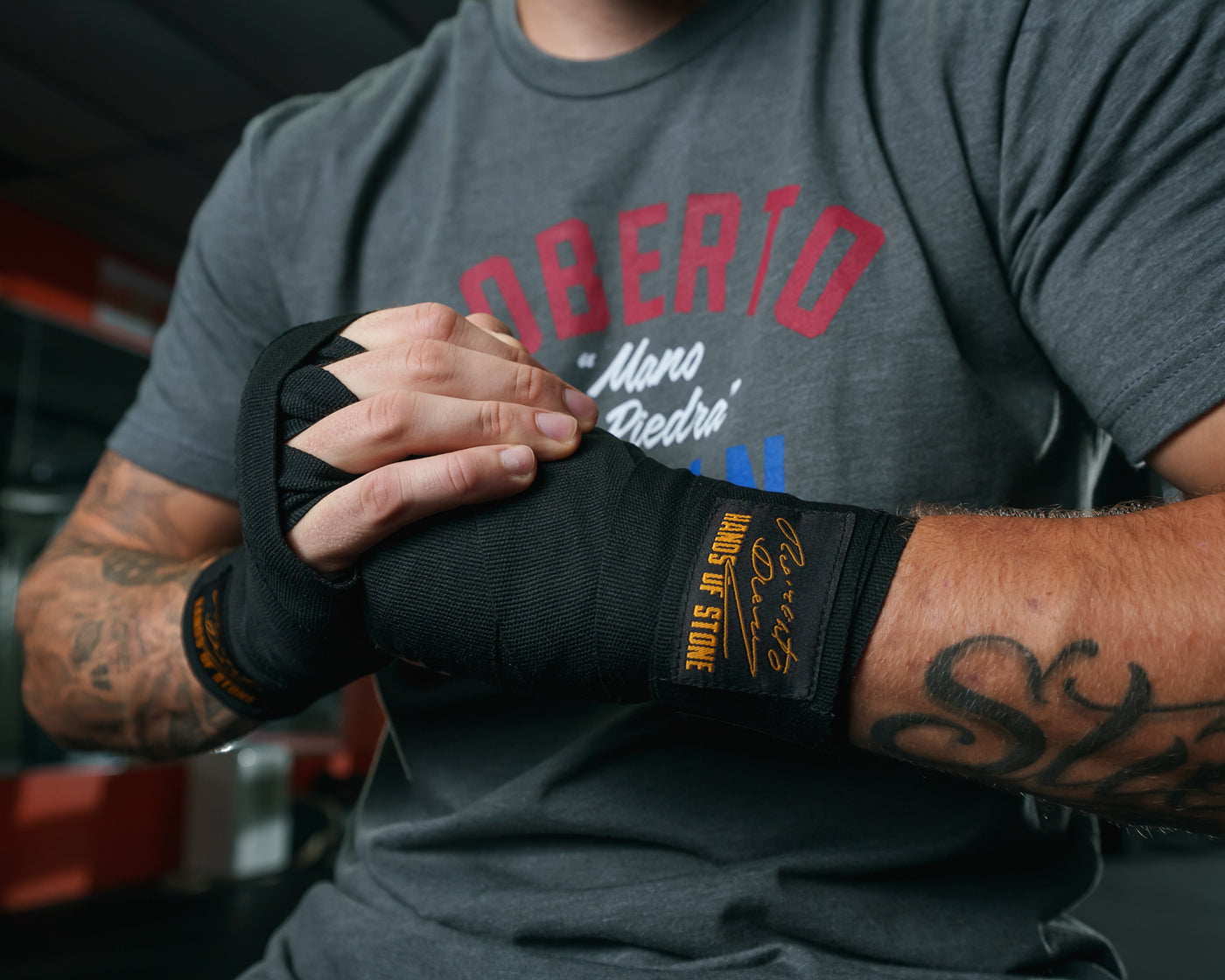 variant:lifestyle::TITLE Boxing Roberto Duran Hand Wraps guy holding fist